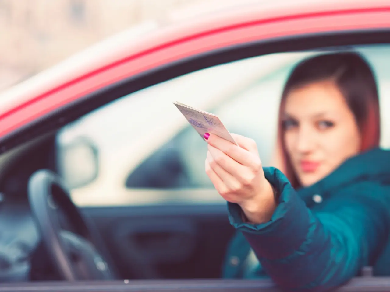 New resident showing a driver's licence while driving in British Columbia