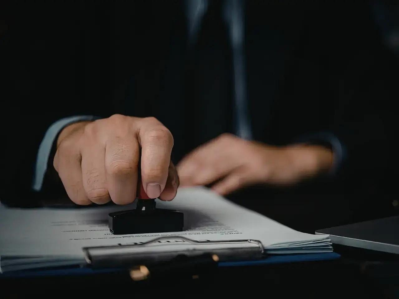 Official document being stamped during the authentication process.