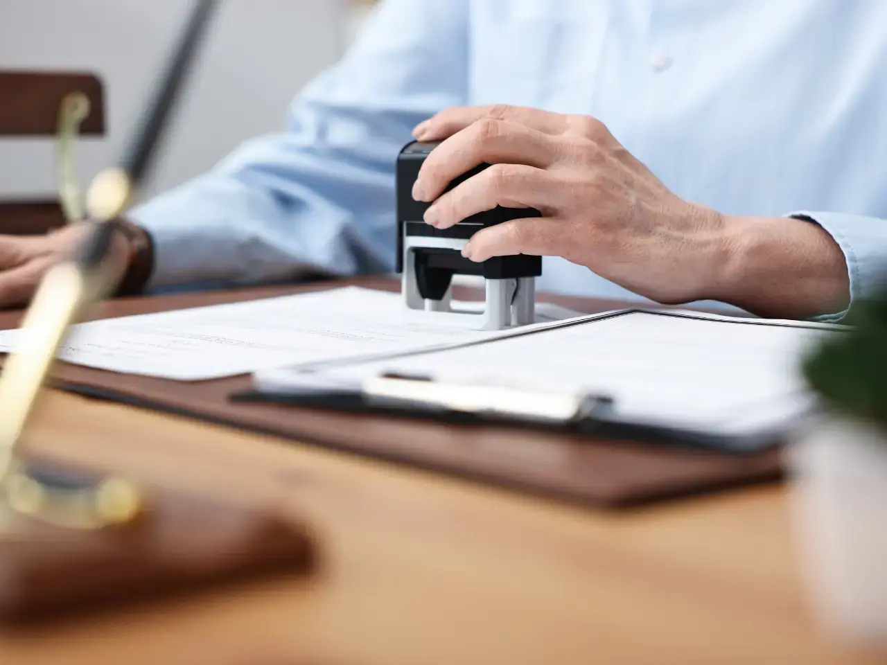 Notary stamping paperwork for legalization or authentication.