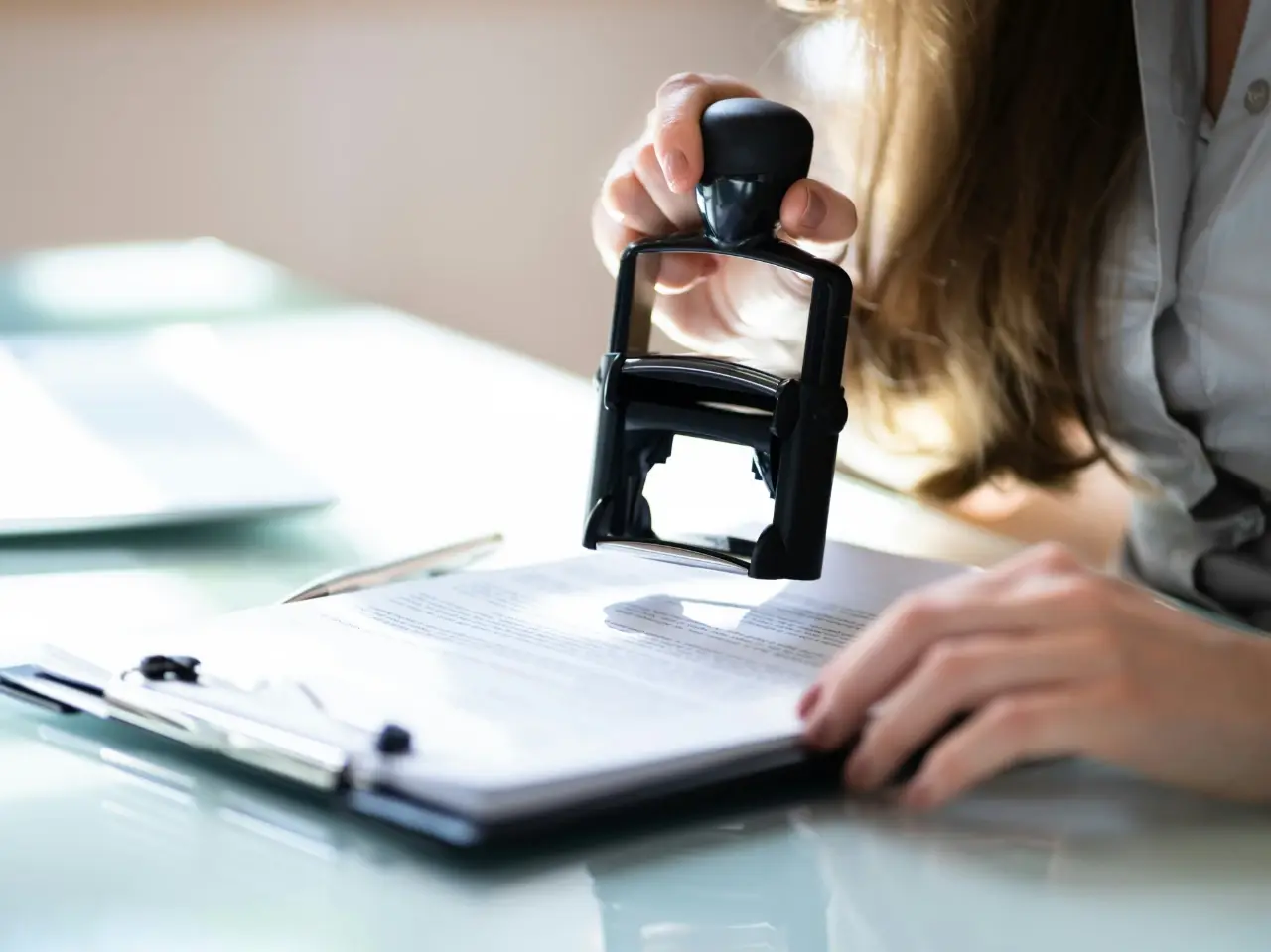 Notary public placing an official stamp on documents during the apostille process in Canada.