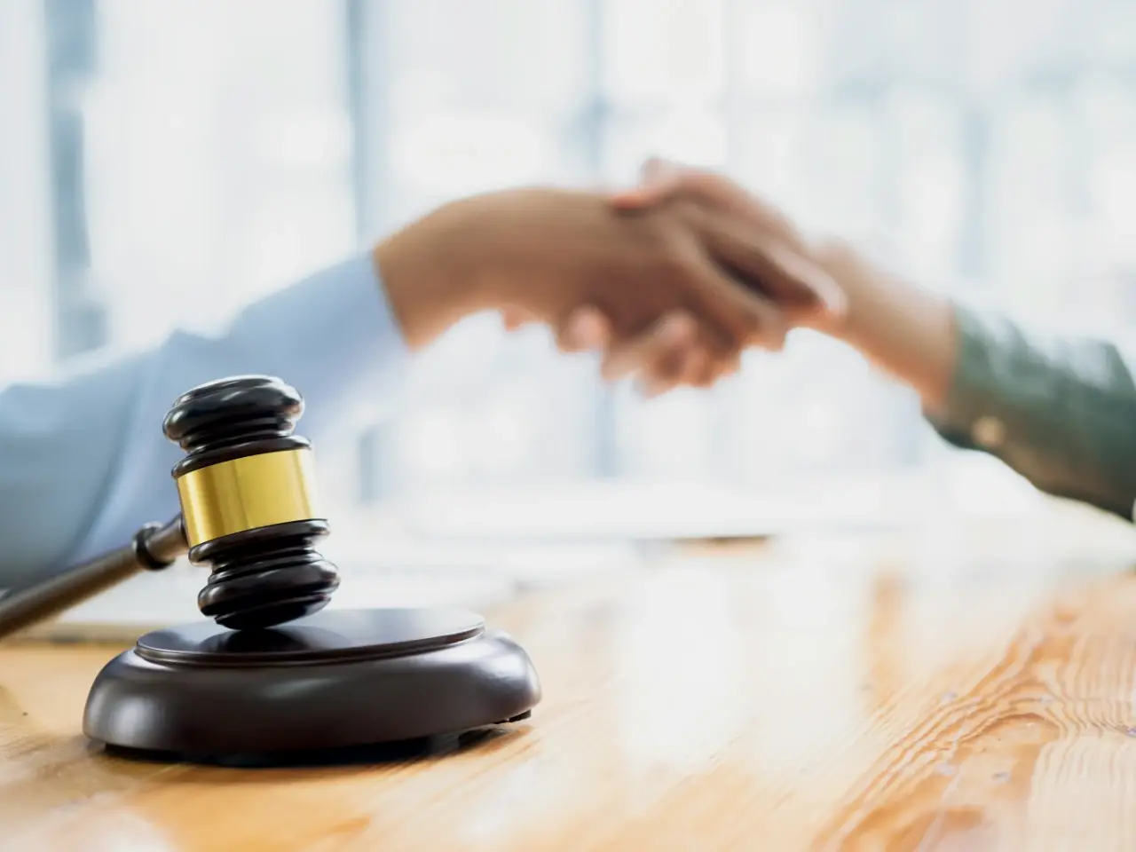 Handshake between lawyer and client clarifying common misconceptions about notaries and apostilles in Canada.