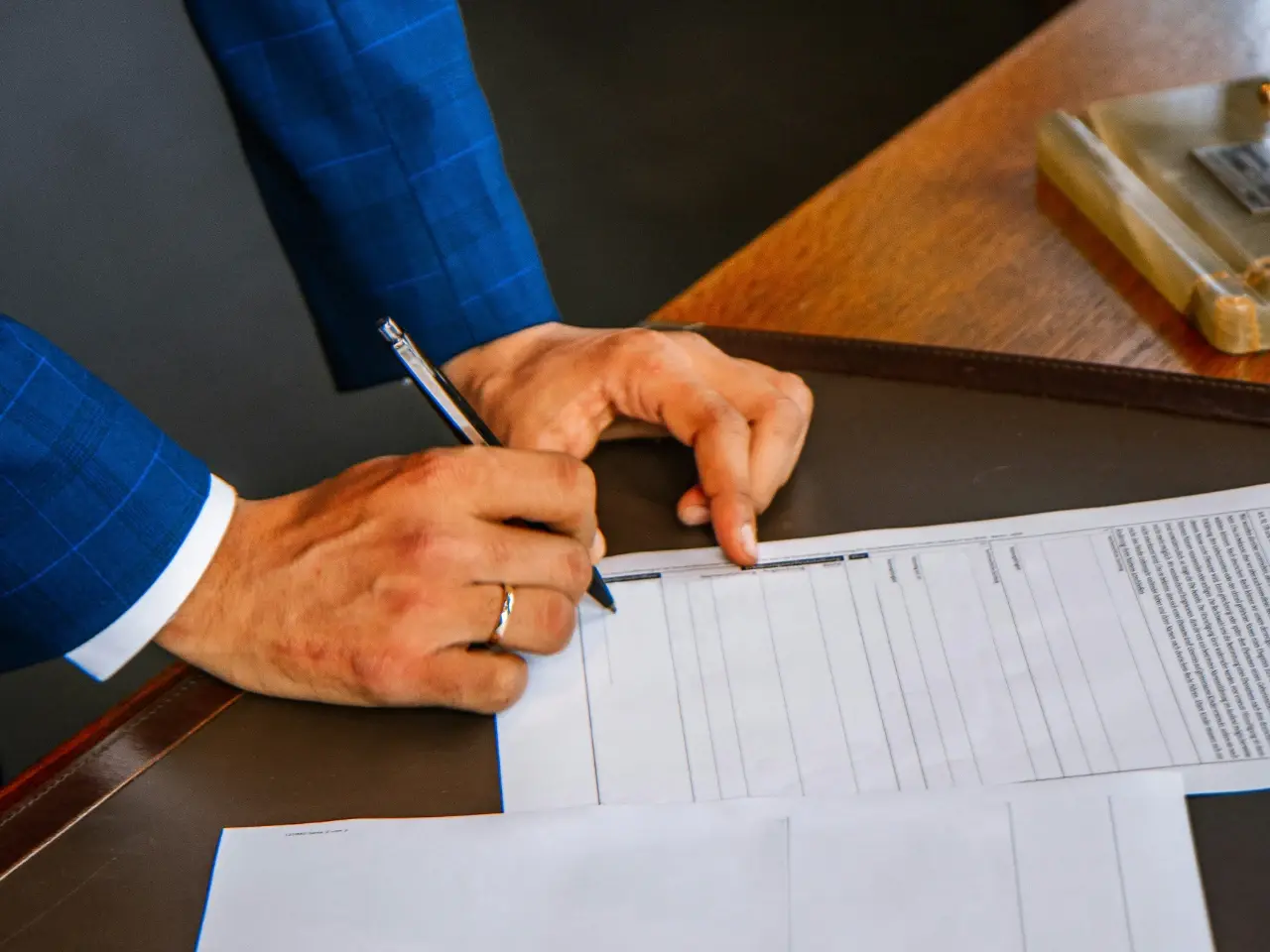 Professional signing official paperwork to authenticate a document correctly in Canada.