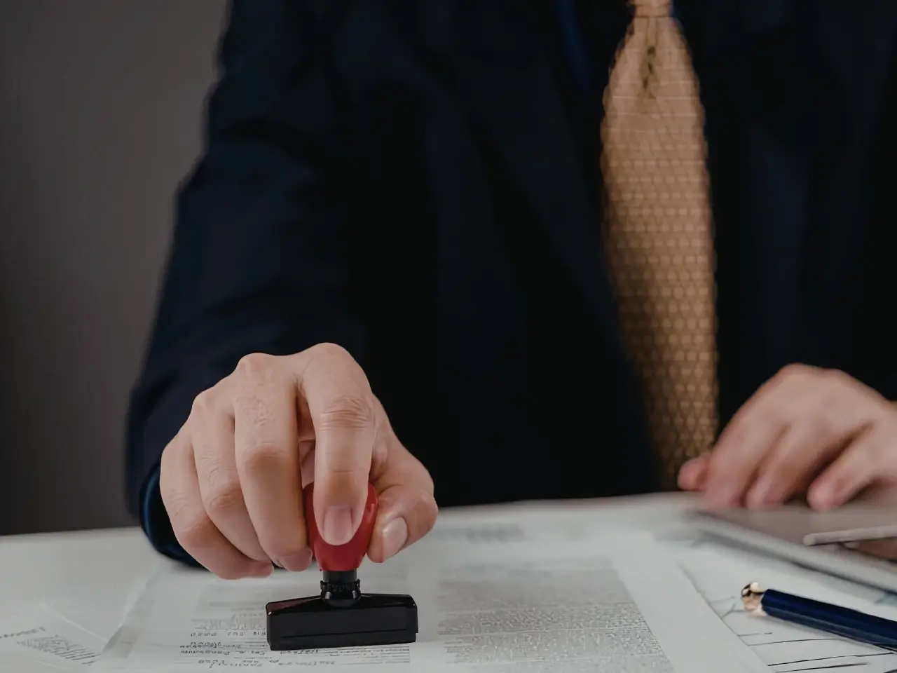 Notary stamping documents during the authentication process in Canada.