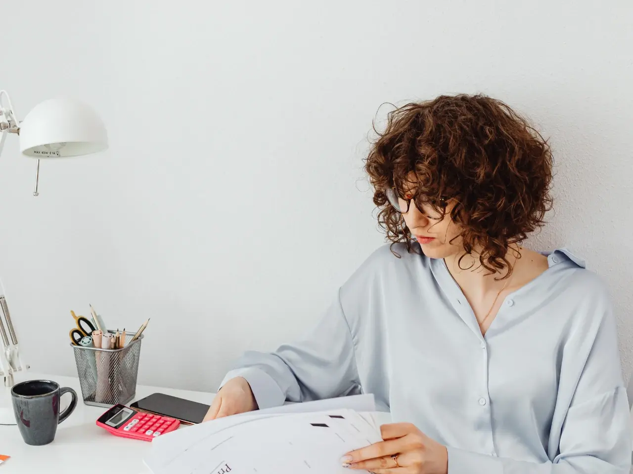 Person gathering documents for degree attestation requirements.