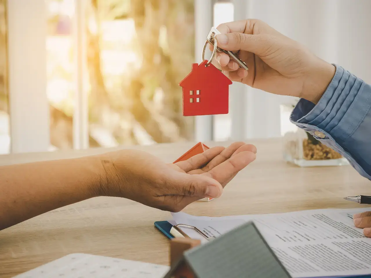 Handing over house keys represents completing a property purchase in Mexico.