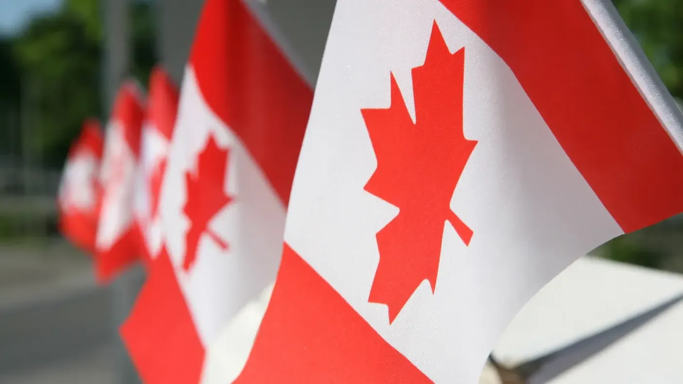 Canadian flags representing permanent residence and immigration to Canada.