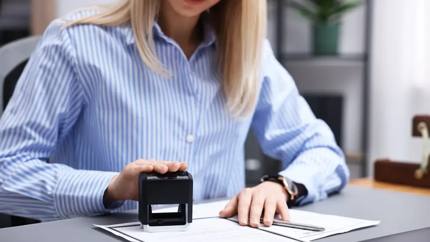 An expert is stamping official documents for the Global Affairs Canada apostille and authentication process.