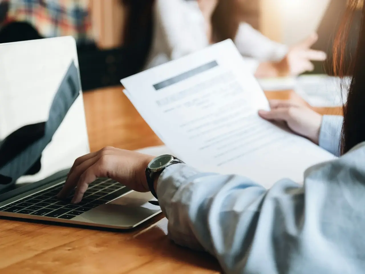 Person reviewing documents on a laptop to avoid common apostille and authentication mistakes in Canada.