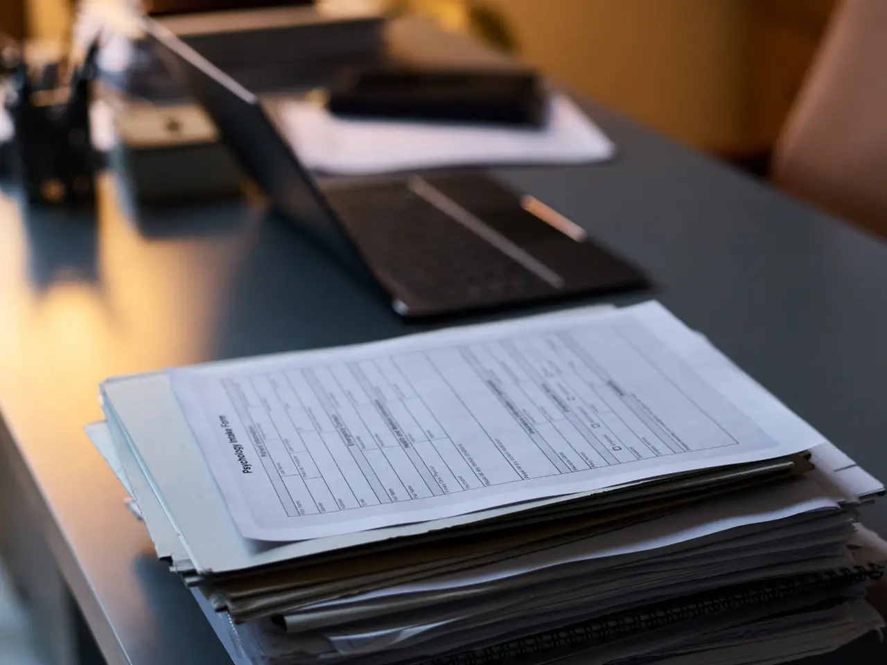 Stack of documents prepared for police clearance attestation submission.