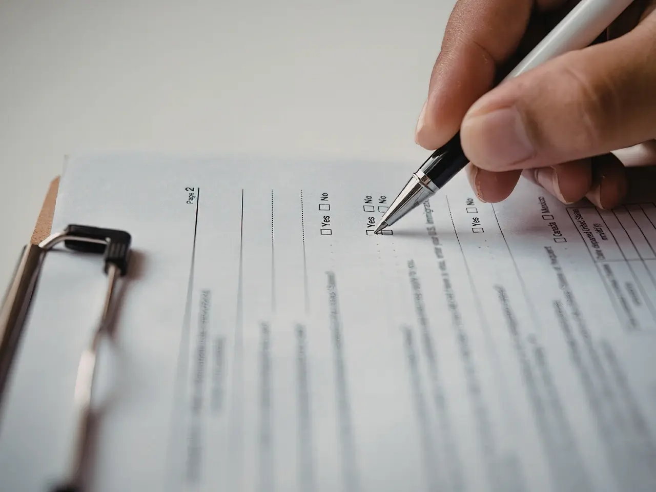Signing police clearance forms during the application process.