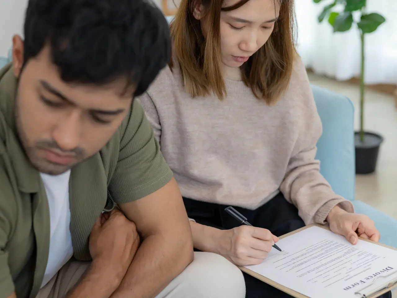Ex-spouses looking over divorce papers and court documents together.