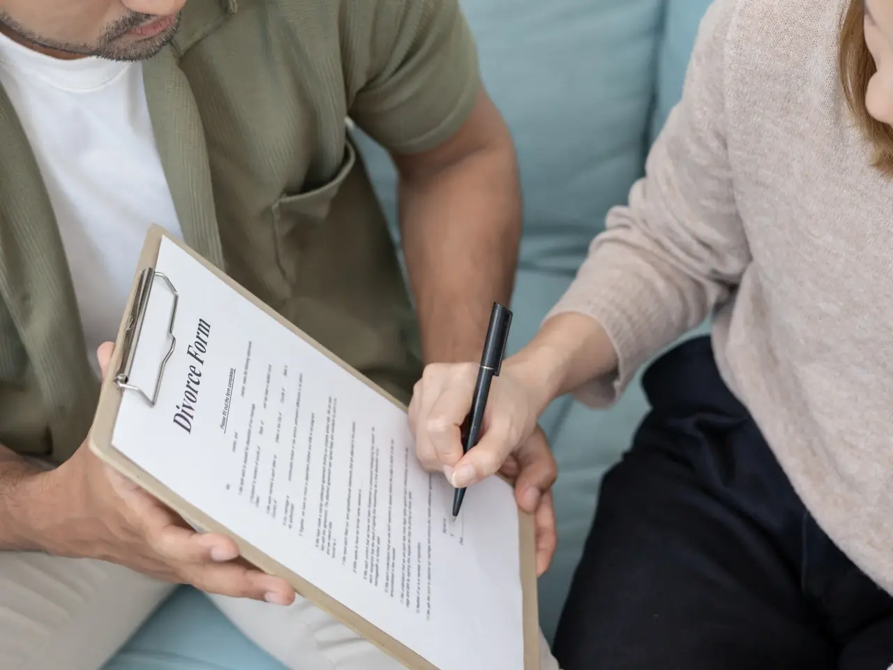 Completing and signing a divorce certificate application form.