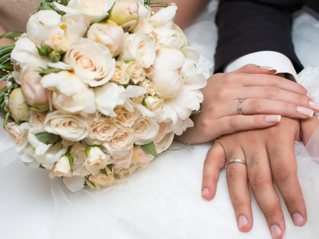 Newly married couple’s hands with rings, representing a legally registered marriage in Ontario.