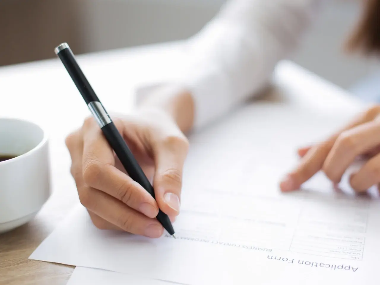 Person completing an Ontario marriage certificate application form.
