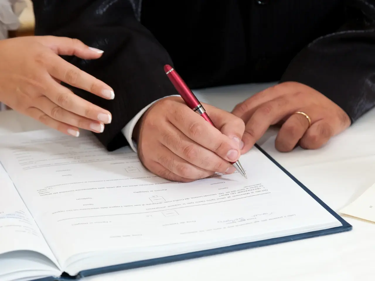 Signing official records, representing legal use of an Ontario marriage certificate.