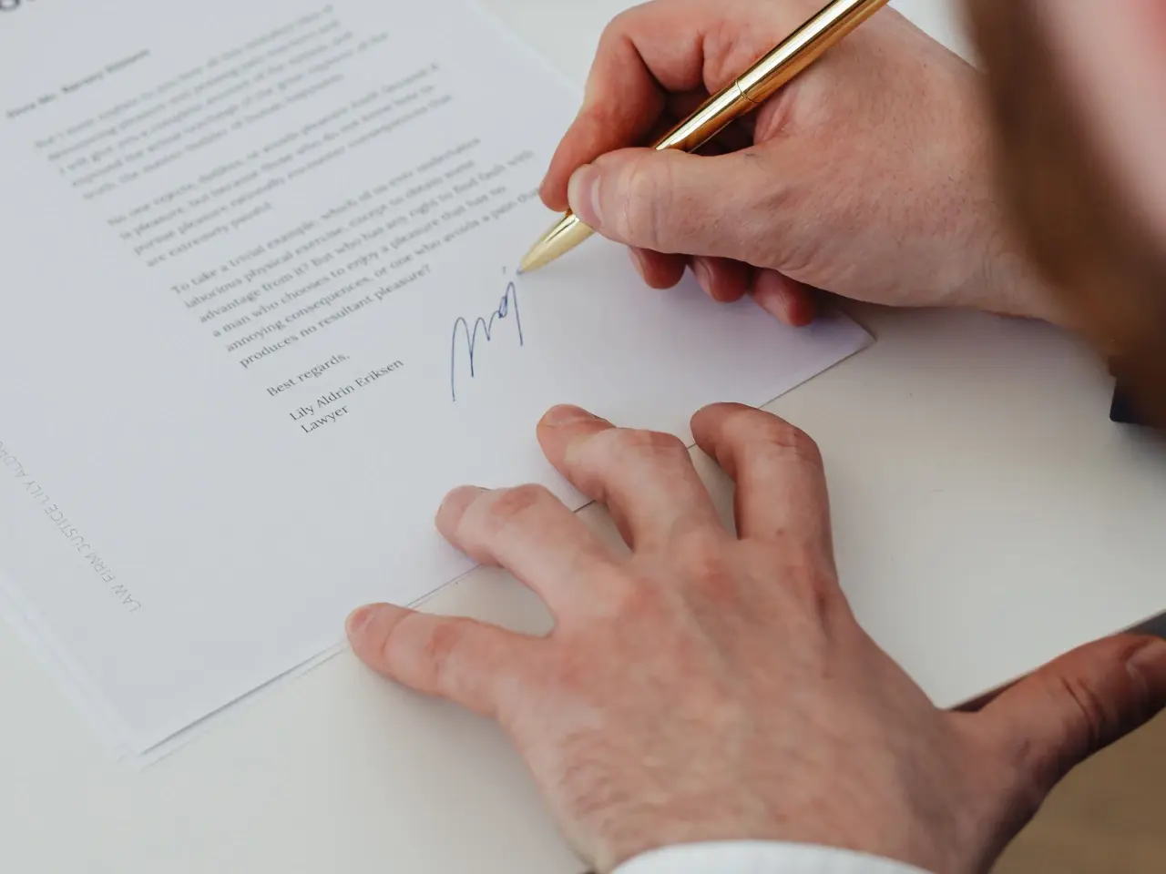 Person signing a power of attorney document, highlighting when a POA takes effect after proper signing and witnessing.
