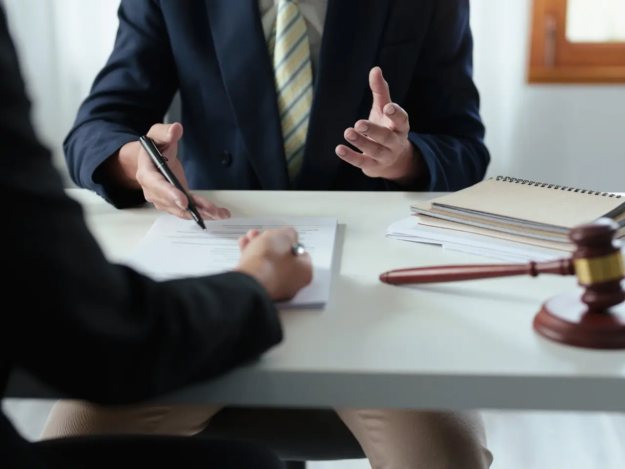 Lawyer consulting with a client and legal documents, representing notarization and legalization of a Canadian power of attorney for use abroad.