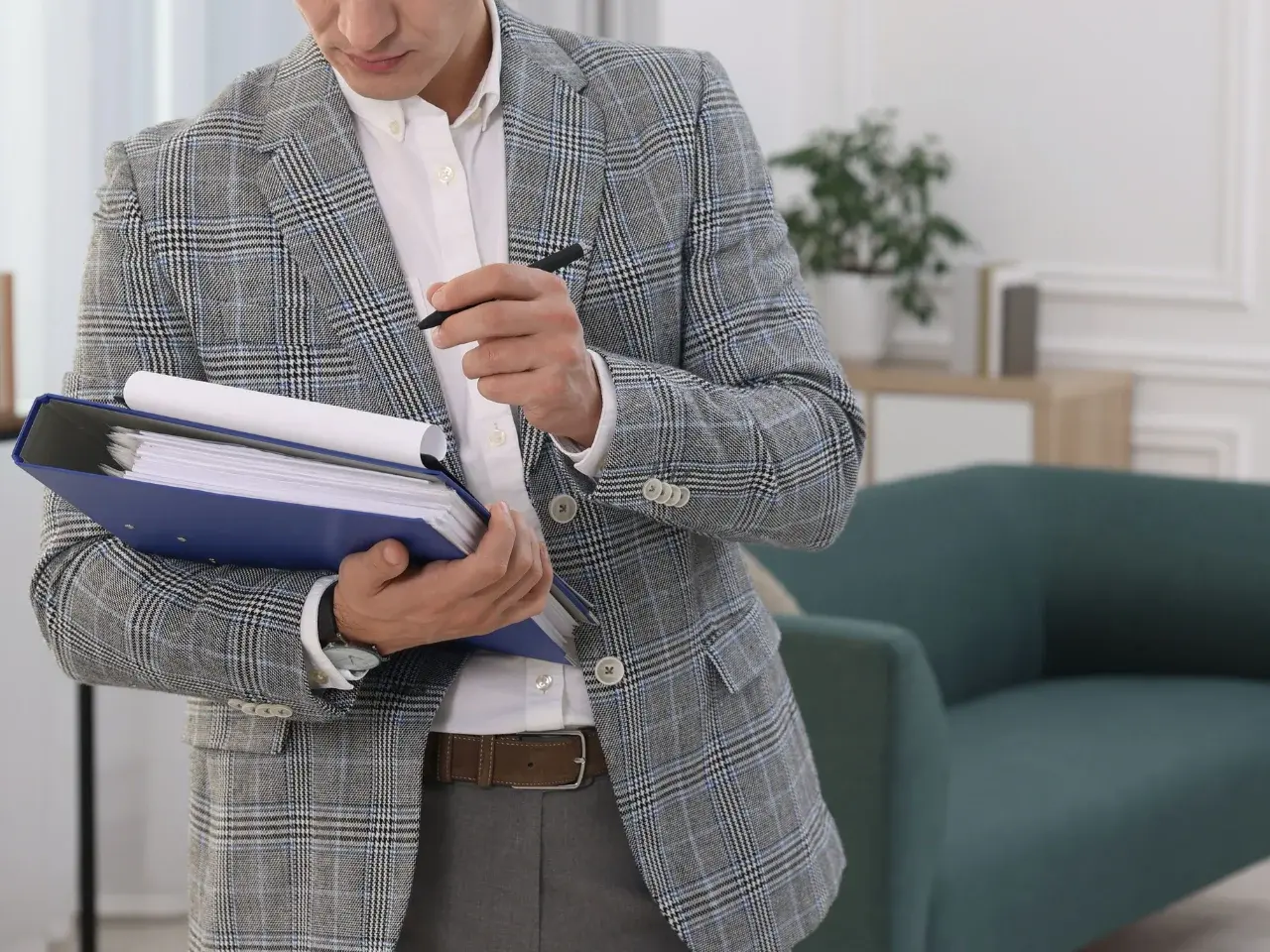 Man holding binders and legal documents for Canadian birth certificate apostille application.