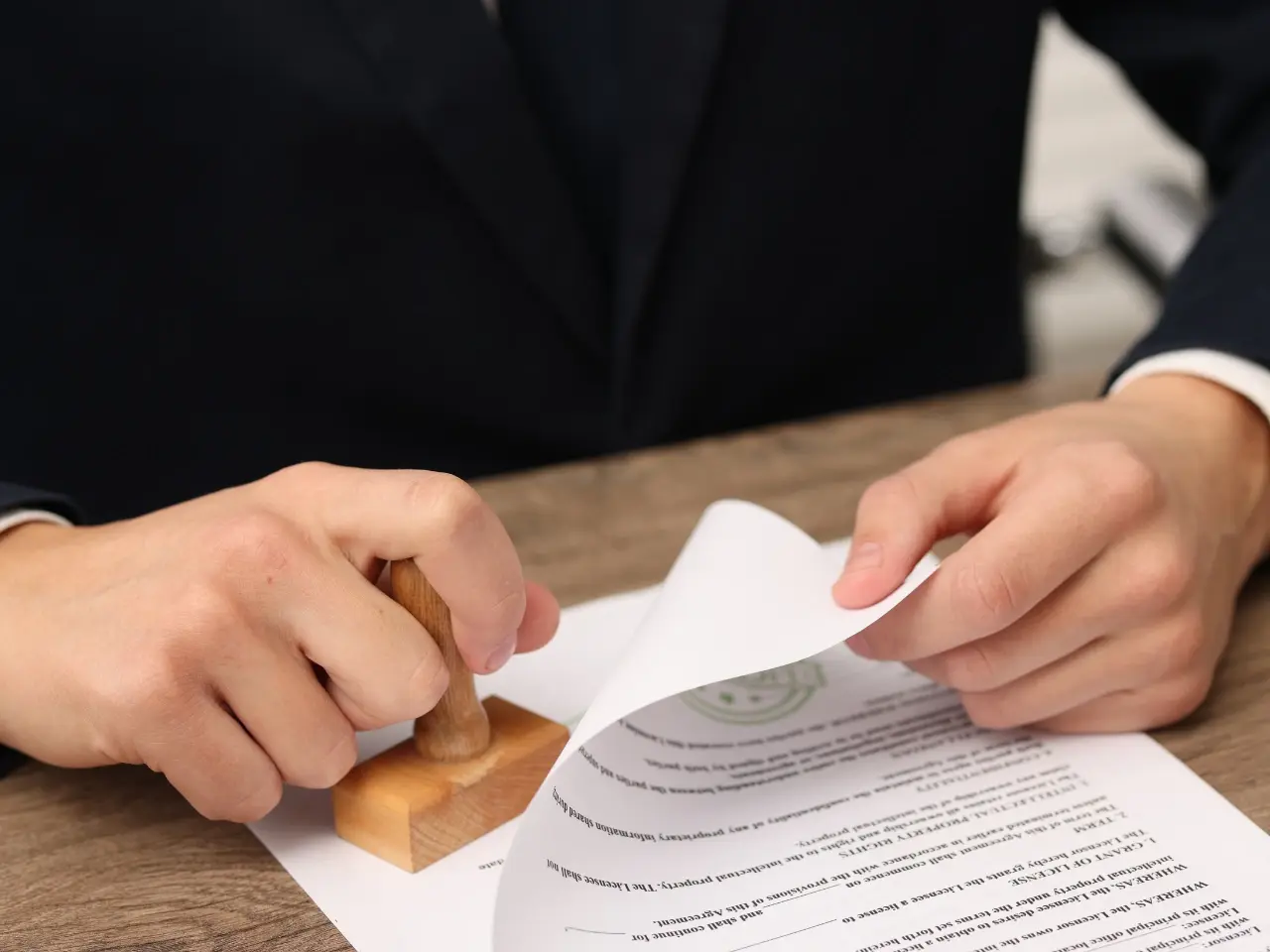 Official applying a stamp to authenticate a Canadian marriage certificate before apostille issuance.