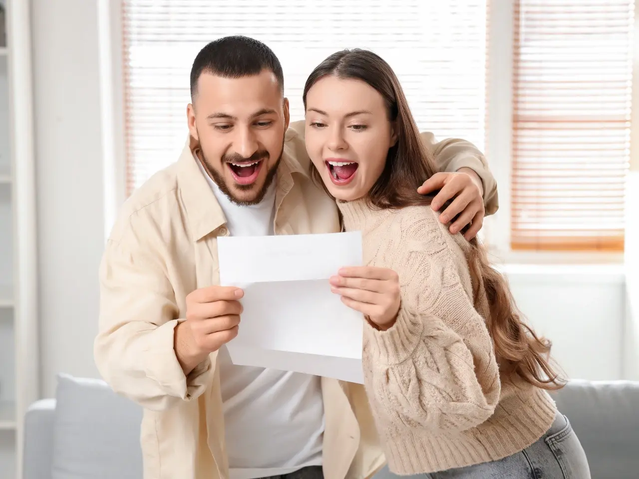 Happy couple holding their apostilled Canadian marriage certificate.
