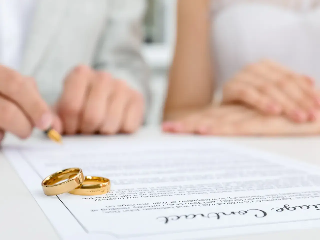 Couple signing the marriage certificate for legal verification.