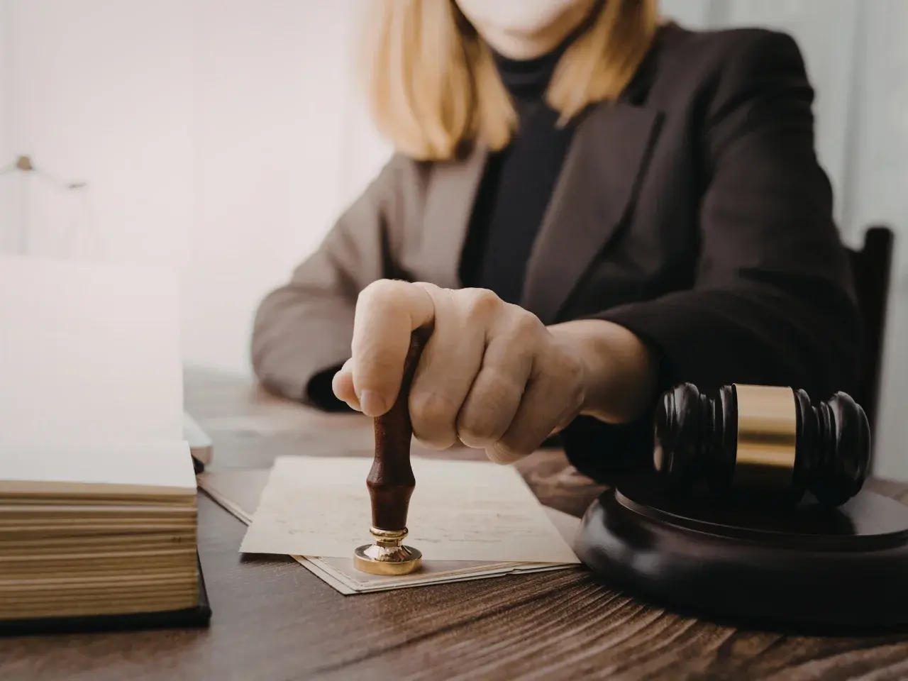 Notary public stamping a document to certify a signature, illustrating what it means when a document is notarized.