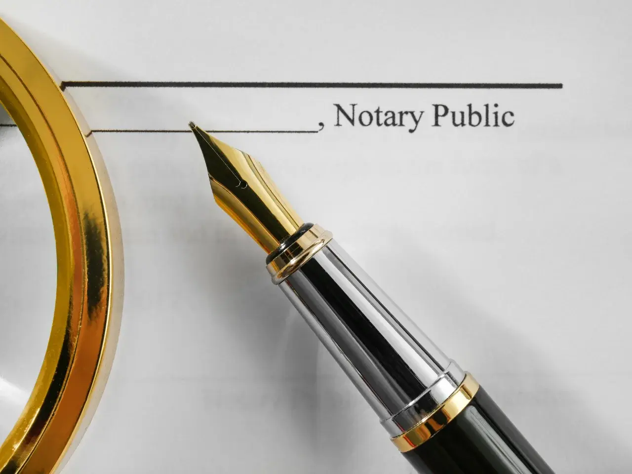 Notary public document with signature line and pen, representing the legal role of a notary public in Canadian law.