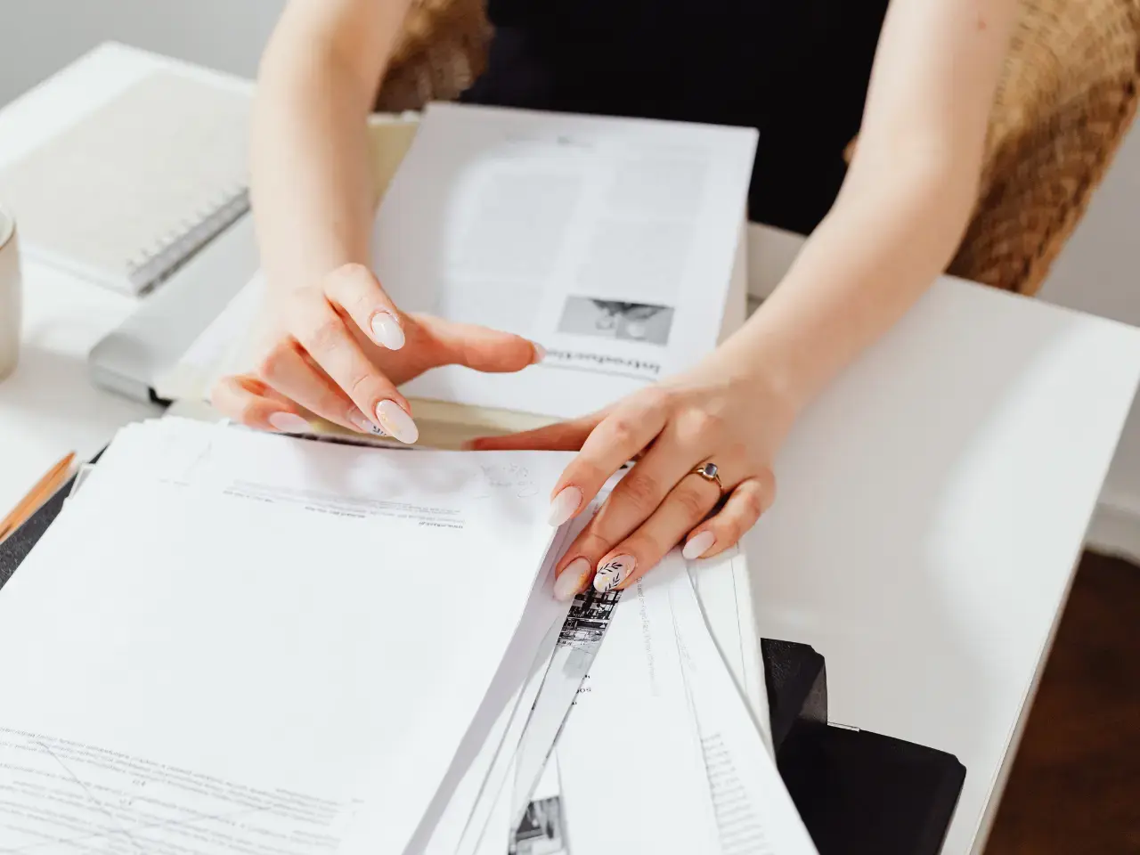 Hands organizing official Ontario paperwork, illustrating which documents qualify for ODS authentication or apostille.