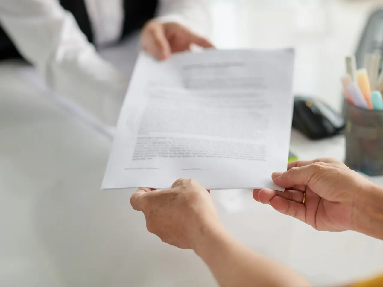 Person reviewing official paperwork, representing Canada’s process of issuing a statement in lieu (instead) of a traditional certificate of non-impediment.