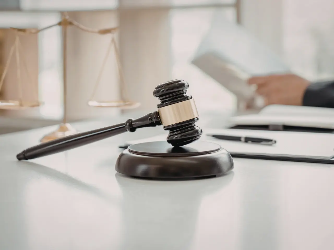 Court gavel beside documents requiring authentication.