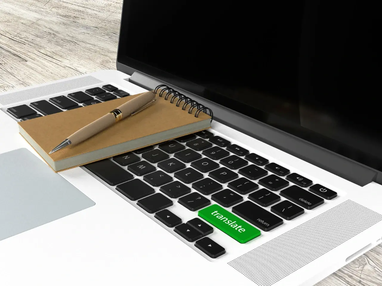 Close-up of a laptop keyboard with a green “translate” key, notebook, and pen, representing online document translation services.