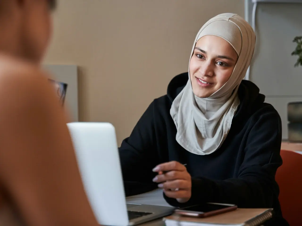 Advisor explaining document attestation requirements to a client during a meeting.