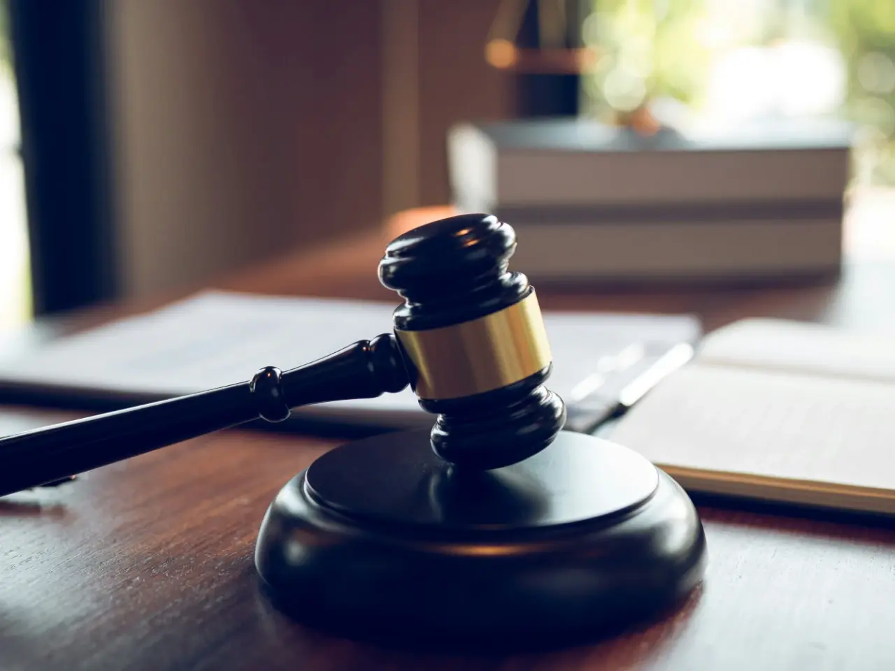 A gavel and documents on the table symbolize the attestation process.
