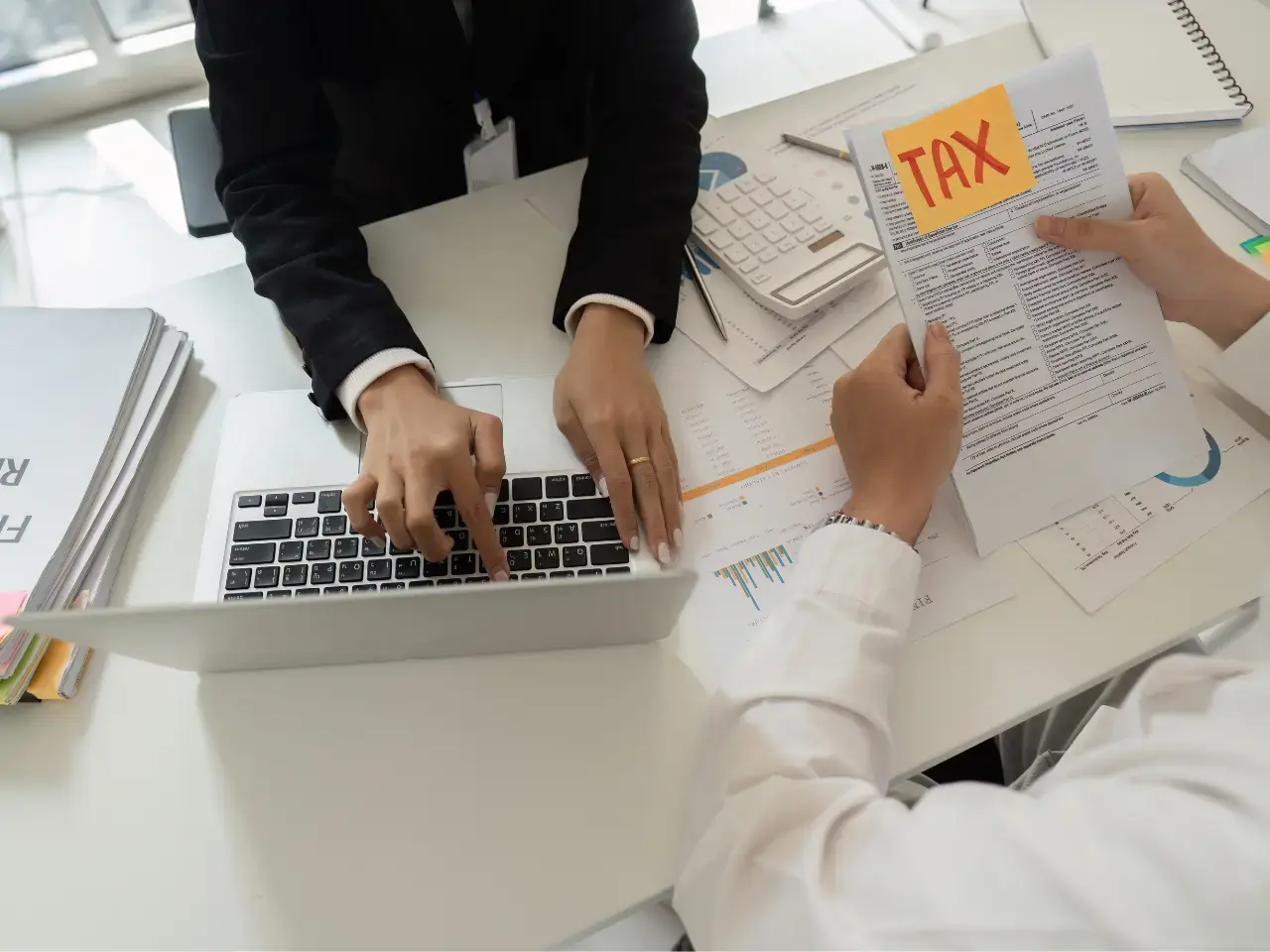 Professional reviewing foreign income documents on a laptop, representing how a CRA tax residency certificate confirms tax residency for treaty benefits.