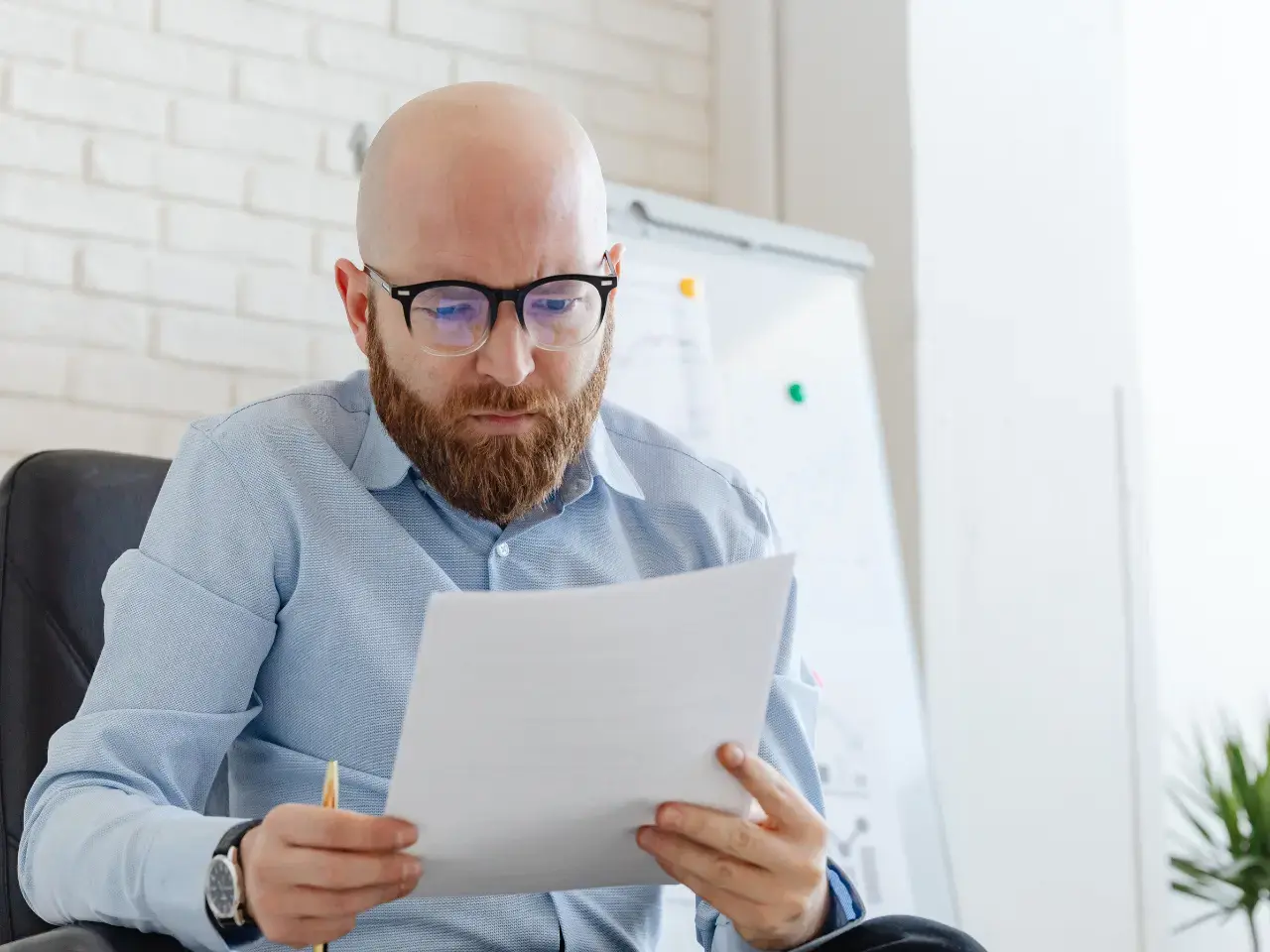 Man reviewing official documents, illustrating how a tax residency certificate is used with foreign tax authorities to claim treaty benefits and avoid double taxation.