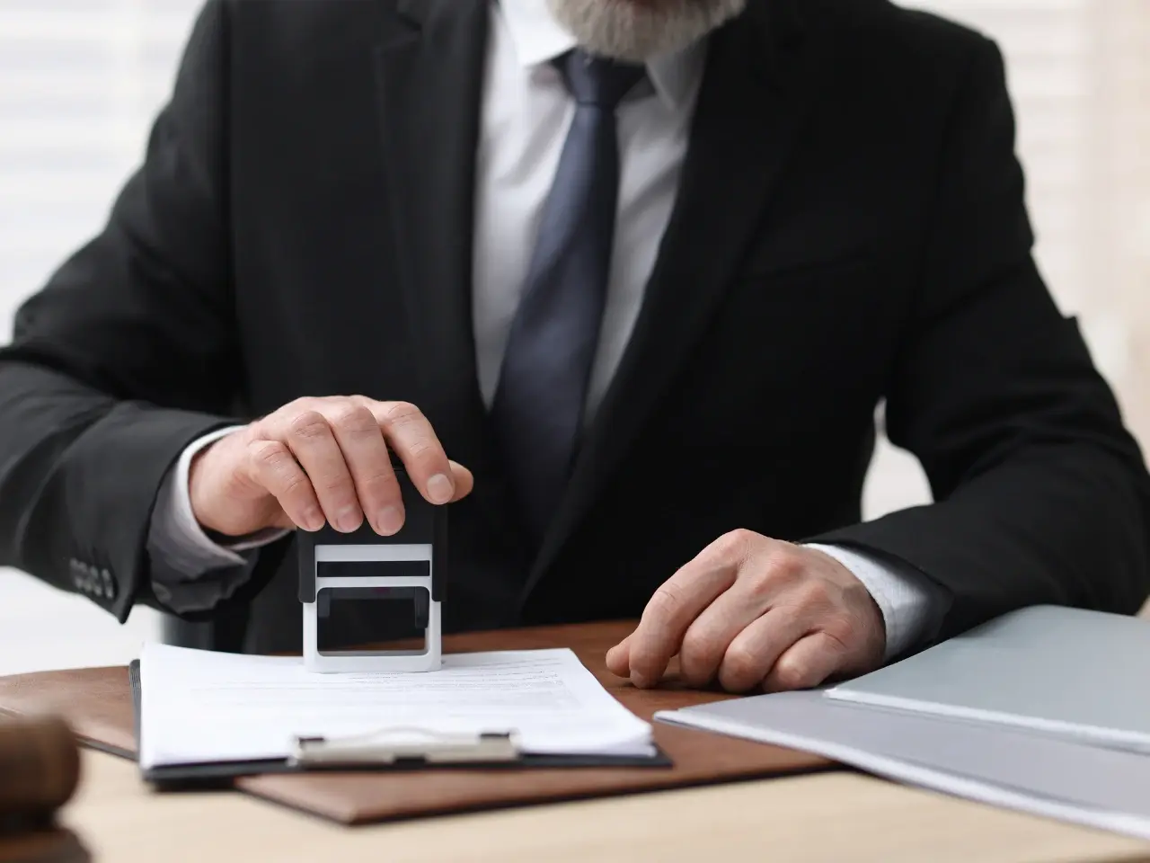 Notary stamping official documents for apostille certification.