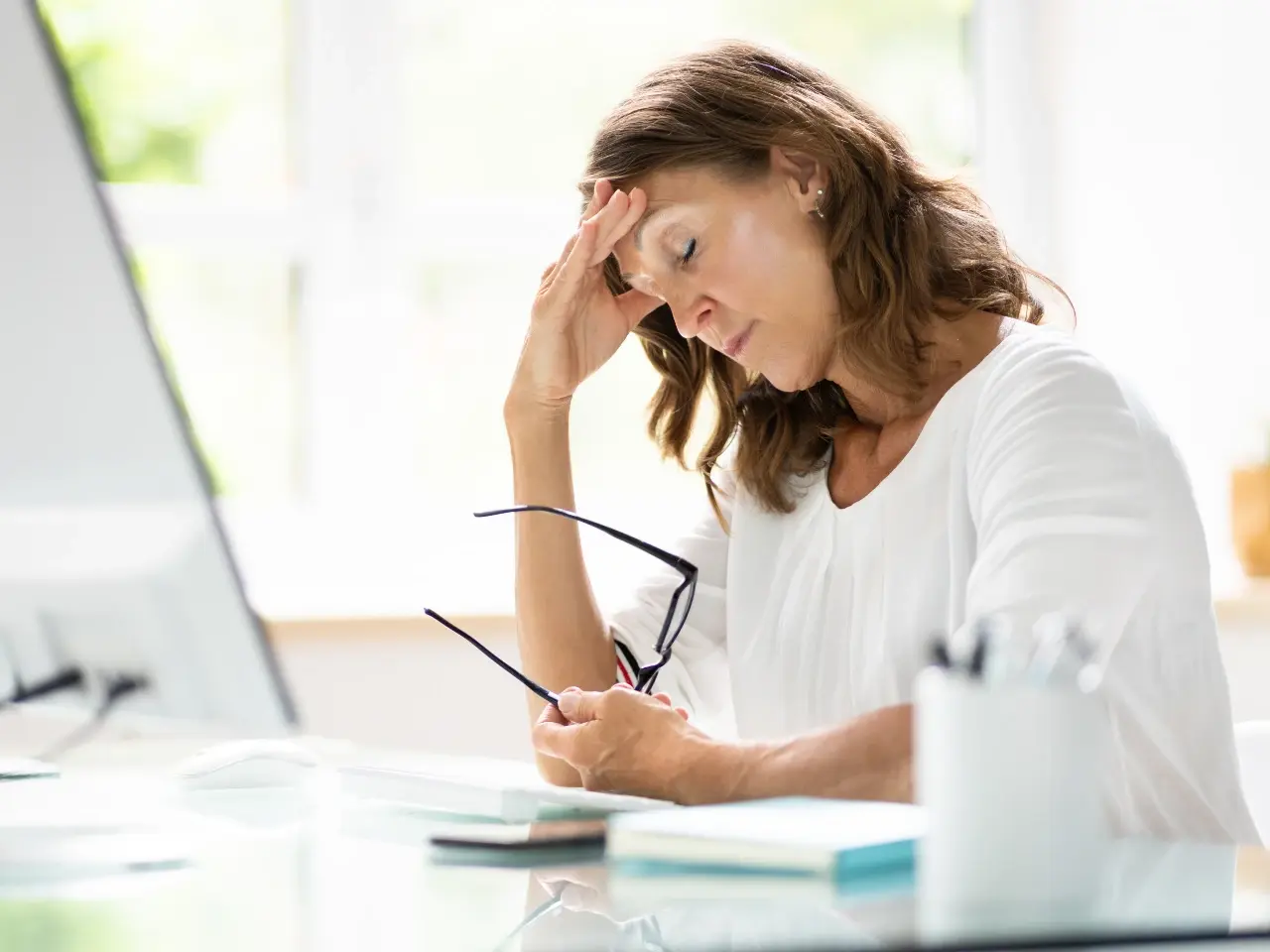 Person stressed while reviewing documents for apostille application.