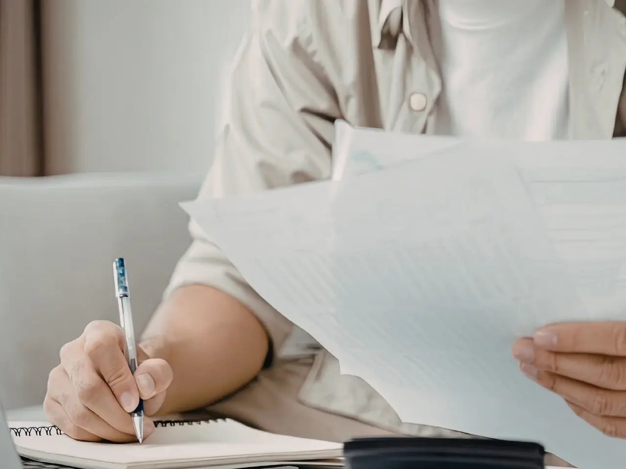 Individual checking official paperwork required for international legalization.