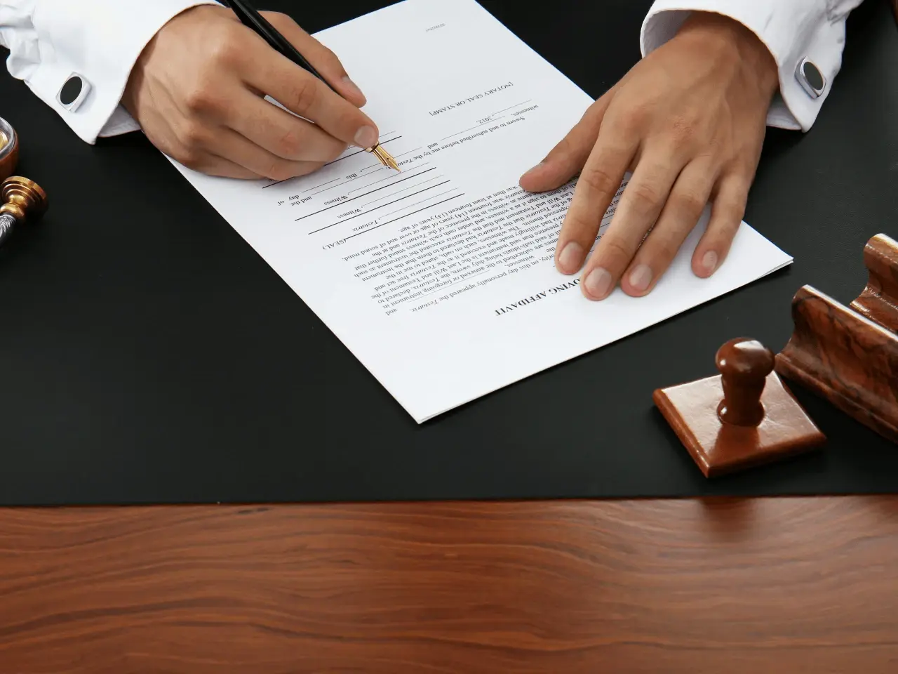 Person filling out an affidavit form required for obtaining a Single Status Certificate in Canada.