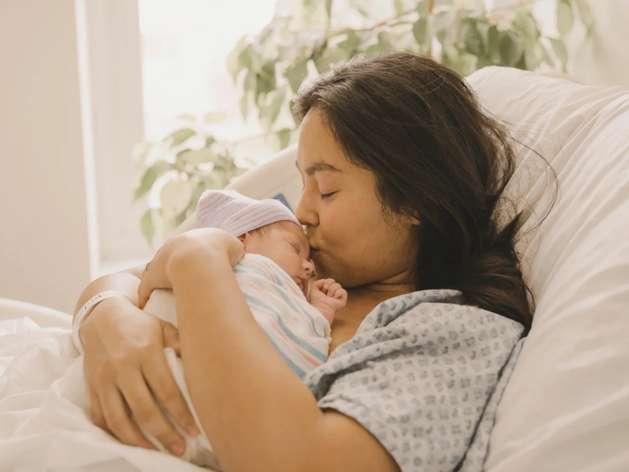Canadian parent holding a newborn child born abroad for Canadian citizenship.