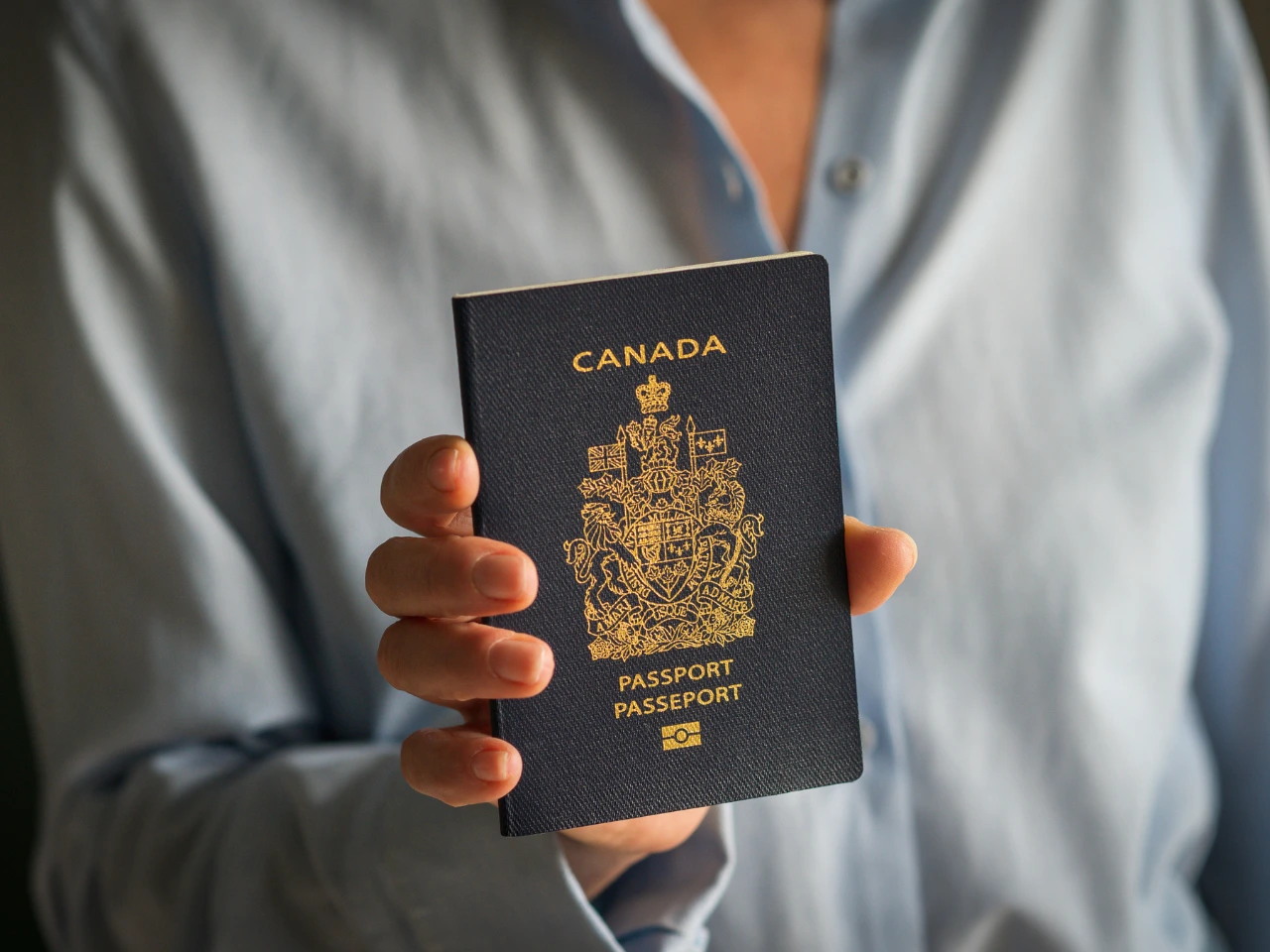 Canadian passport representing obtaining and holding Canadian citizenship.