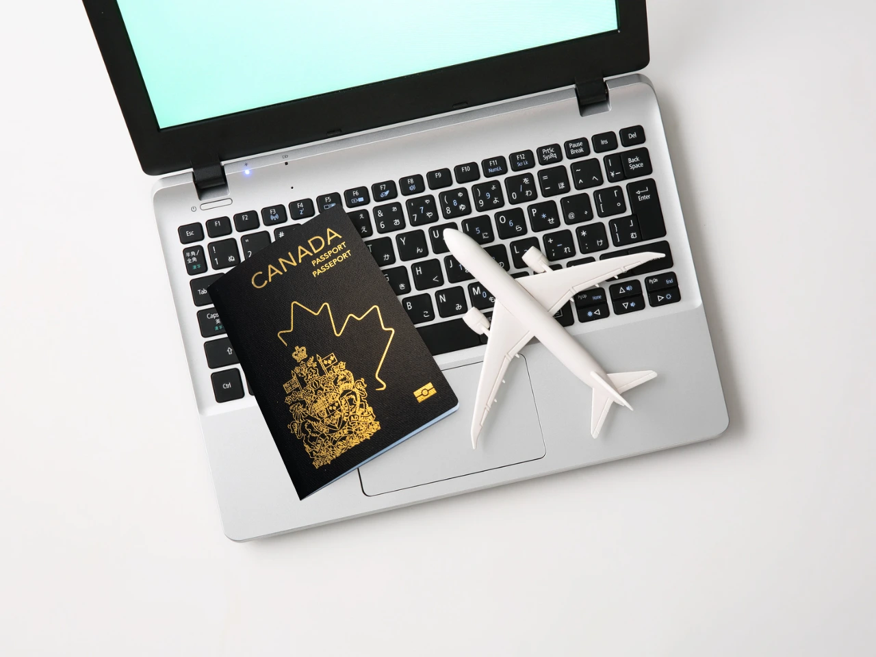Canadian passport and airplane representing air travel requirements for dual citizens.