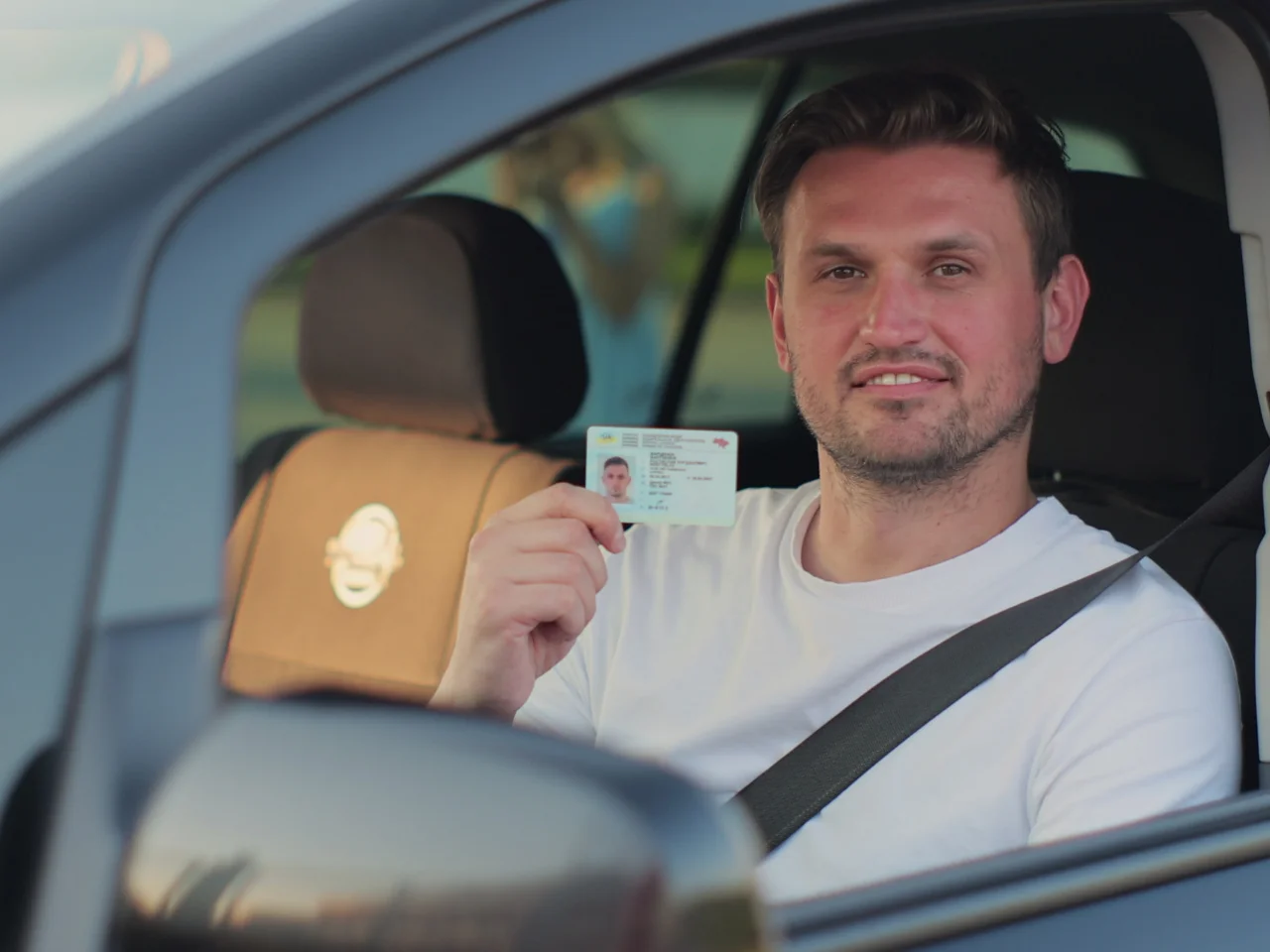 New Alberta resident holding an Alberta driver's licence after exchanging a foreign driver's licence.