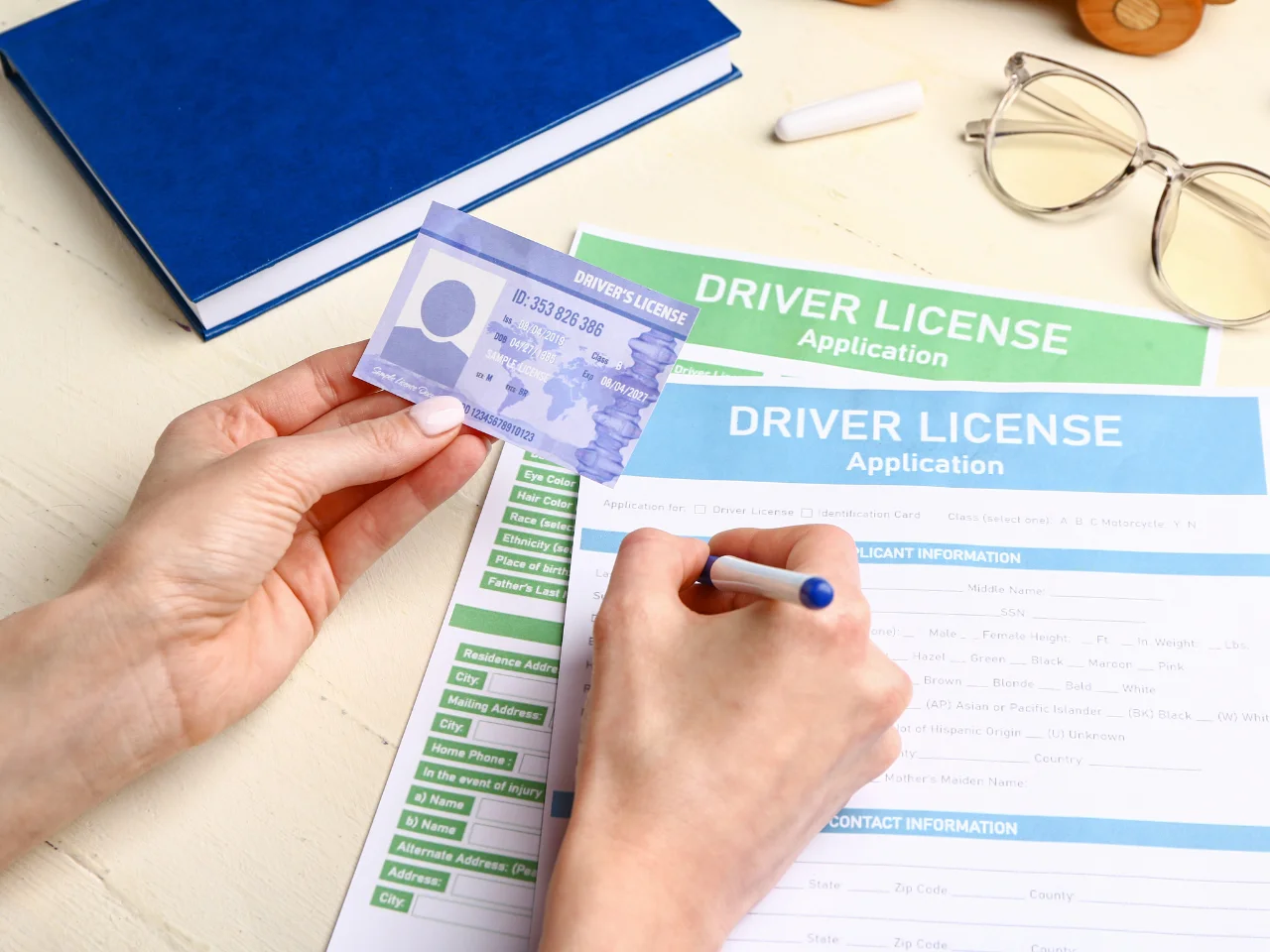 Applicant completing an Alberta driver's licence application with a driver's licence for exchange or renewal.