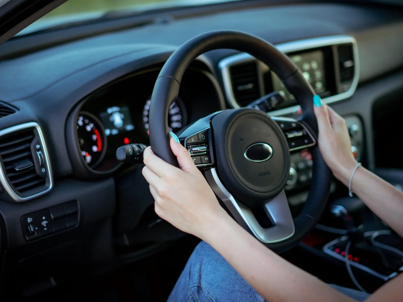 Driver operating a vehicle during a practical driving test, representing Quebec driver's licence road test requirements.