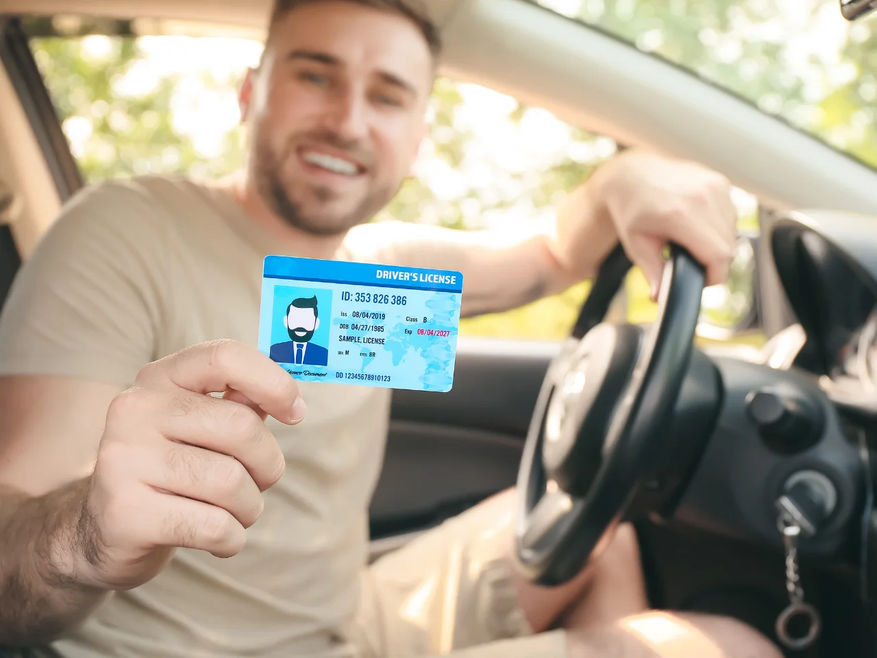 Driver holding a newly issued driver's licence while sitting in a vehicle after completing the Quebec driver's licence process.
