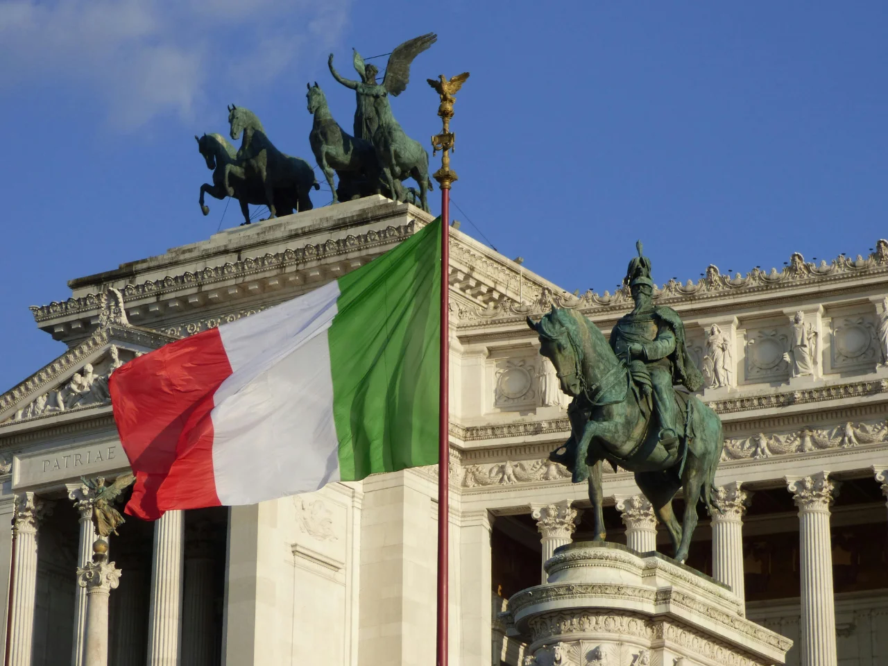 Waving Italian flag symbolizing Italian ancestors and descendants applying for Italian citizenship by descent