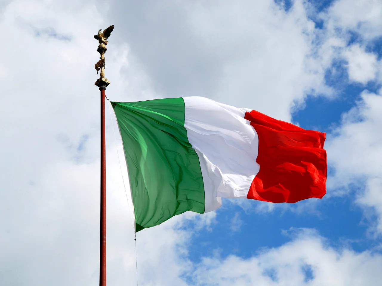 Waiving Italian flag symbolizing ancestors born in Italy.