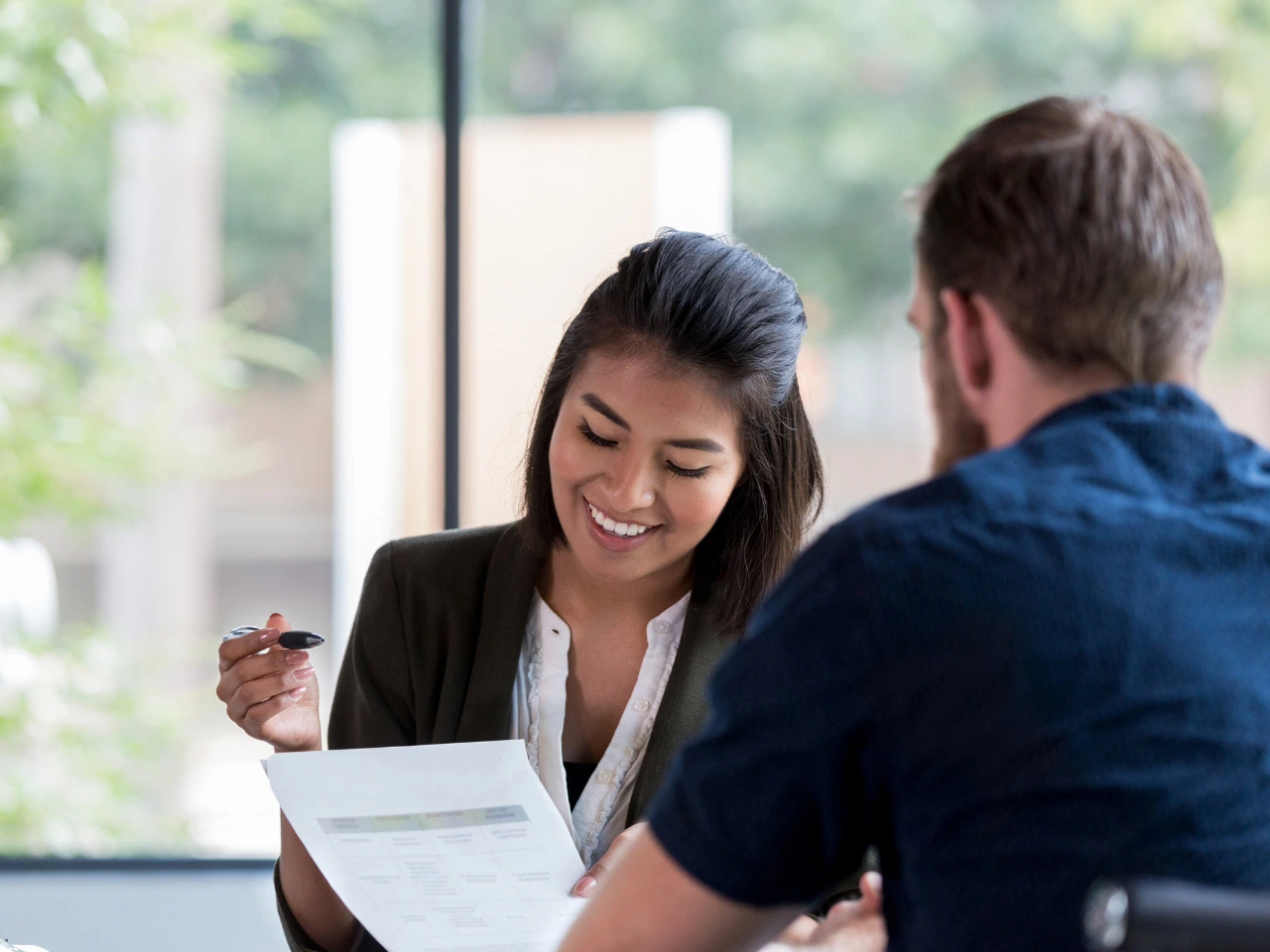 Professional reviewing foreign documents for legal name change translation.