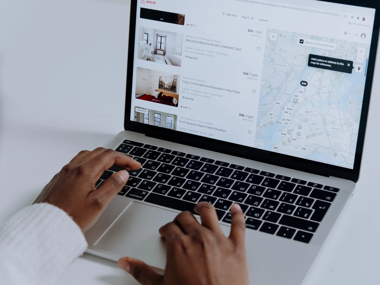 Laptop displaying localized website content for different regions.